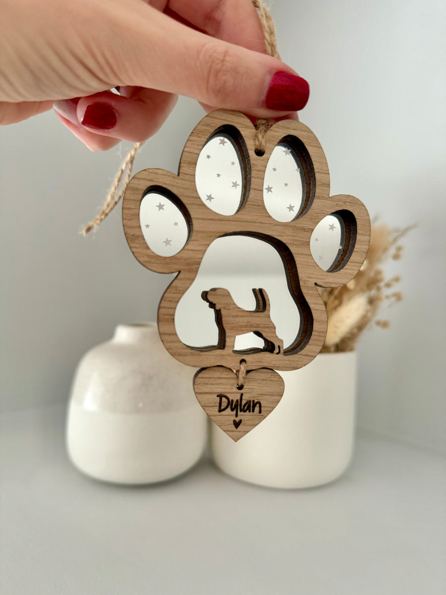 dog memorial gift made from oak veneer and silver mirror acrylic in the shape of a paw with dogs breed silhouette inside. Complete with hanging heart with engraved name